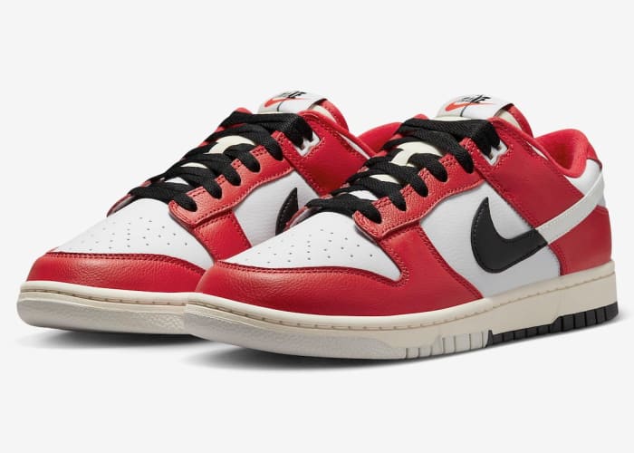 Side view of red, white, and black Nike Dunk sneakers.